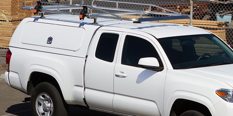 White work truck with custom rooftop cargo frame system