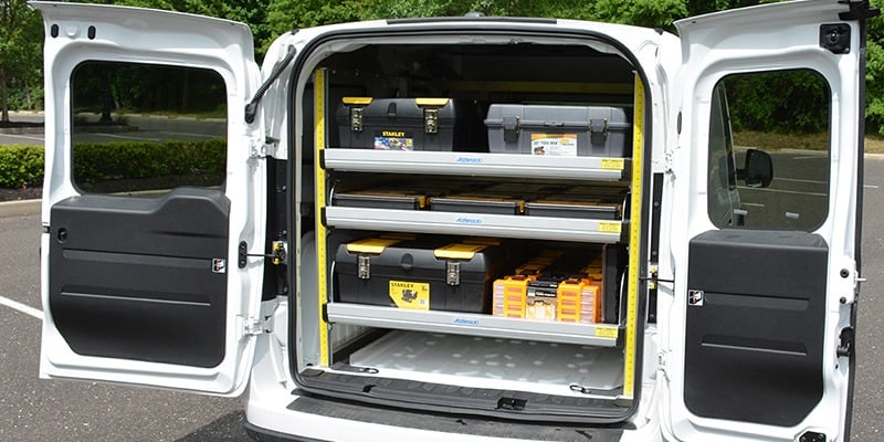 Commercial van with back doors open showing slider shelving system