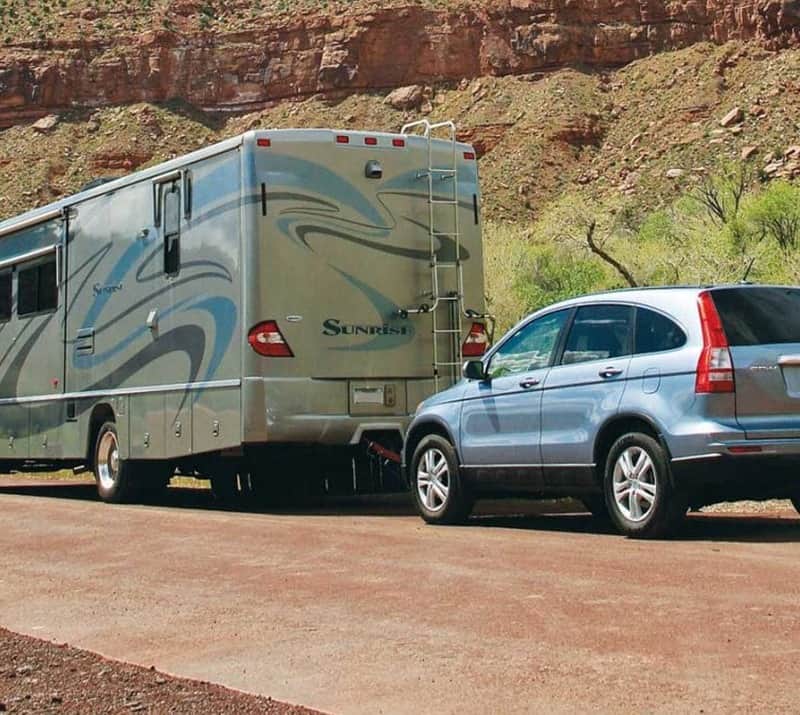 Large RV flat towing Honda CRV in Desert setting