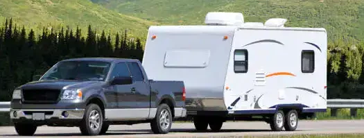 Truck towing a travel trailer on road